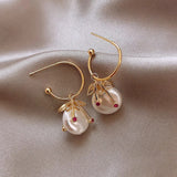 Orecchini retro con perla di ciliegia | Oro