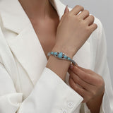 Bracciale aperto a forma di goccia d'acqua turchese | Oro bianco