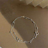 Bracciale regolabile con cuore | Oro bianco