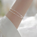 Bracciale regolabile con cuore | Oro bianco