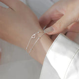 Bracciale regolabile con cuore | Oro bianco