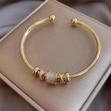 Bracciale regolabile con pendenti | Oro