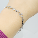 Bracciale con zampe di cane sospese e Osso Grezzo, Edizione limitata | Oro bianco