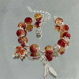 Bracciale con foglia d'autunno e farfalla | Oro bianco
