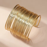 Bracciale aperto con spirale | Oro