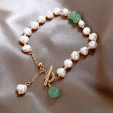 Bracciale retrò con margherite e pietre preziose verdi | Oro