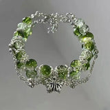 Bracciale retrò con farfalla e perle verdi | Oro bianco