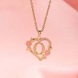 Collana iniziale con charm floreale | Oro
