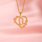 Collana iniziale con charm floreale | Oro