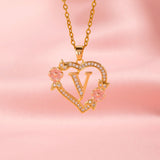 Collana iniziale con charm floreale | Oro