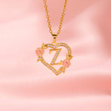 Collana iniziale con charm floreale | Oro