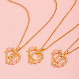 Collana iniziale con charm floreale | Oro