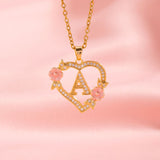 Collana iniziale con charm floreale | Oro